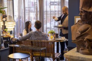 Breakfast service at welcome hôtel Paris - waiter serving tea to a couple - enjoy winter in Paris