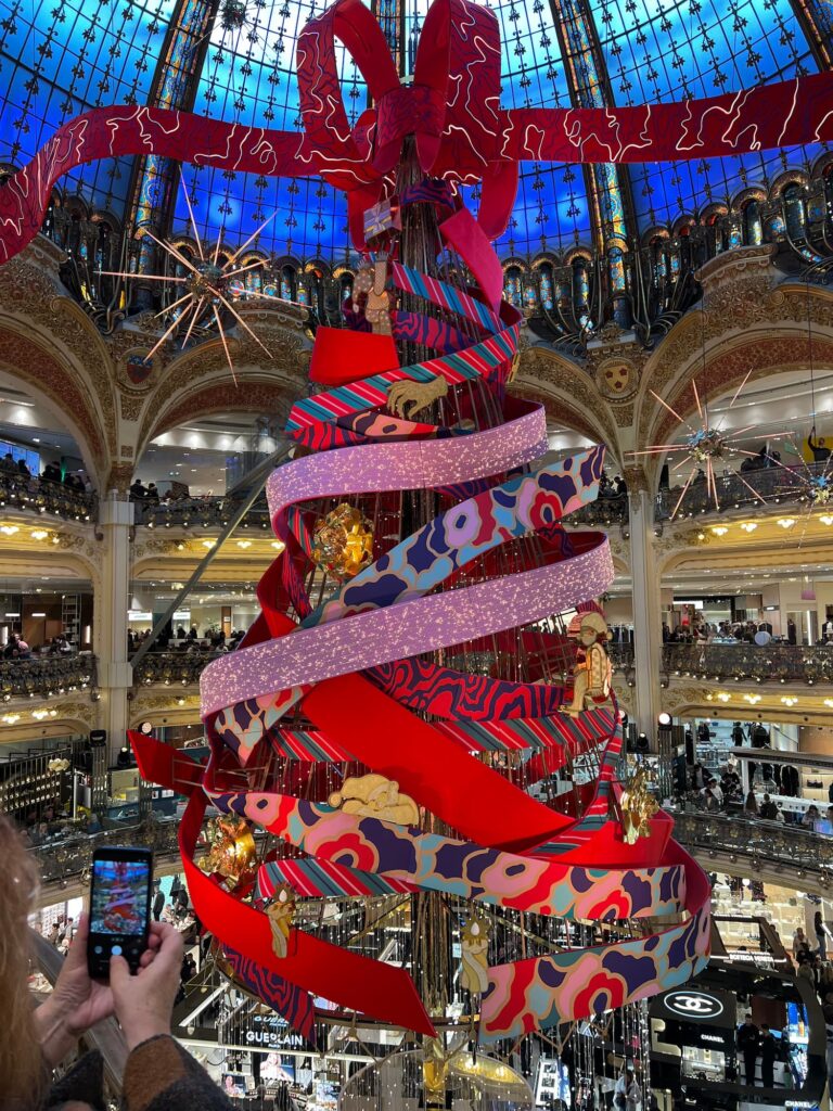 sapin de noël des galeries lafayette avec un grand noeud au sommer sous le dome des galeries | shopping de noël à paris | welcome hotel paris 6