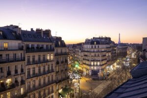 hotel saint-germain boulevard Paris | a city street with buildings and Eiffel tower in the background | Welcome hotel Paris