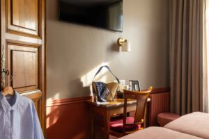 hotel room with a bag on the desk and a shirt in the cupboard | christmas shopping in paris | welcome hotel paris